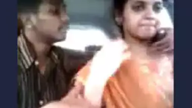 Tamil guy smooching and pressing boobs of cute girl in car