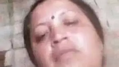 Older Indian widow winks whilst engulfing own large boobs