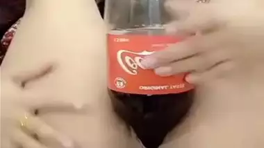 Delhi girl pushes a coca cola bottle in her cunt